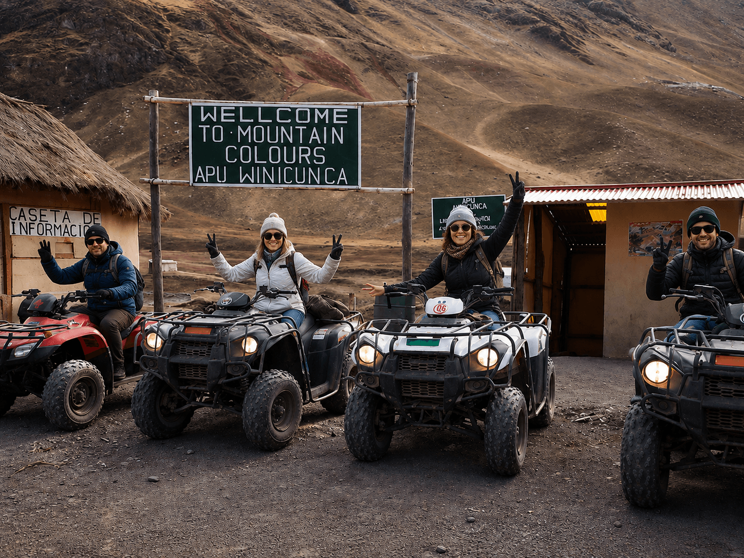 Four travelers on ATVs in front of the Vinicunca welcome sign, surrounded by the high-altitude landscape of the Peruvian Andes.